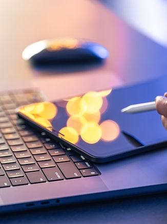close-up-business-hand-with-stylus-pen-working-digital-tablet-laptop.jpg